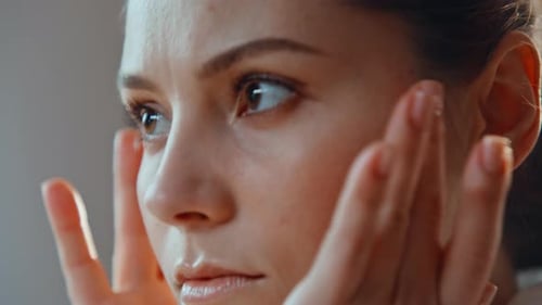 Woman Massaging Cream Into Her Face