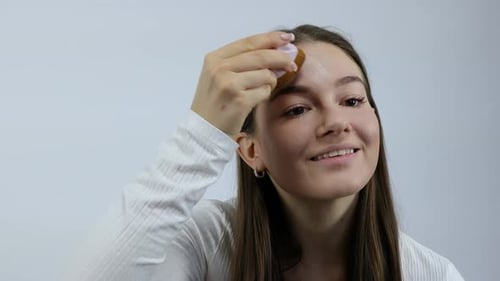 Young Woman Applying Makeup With a Brush
