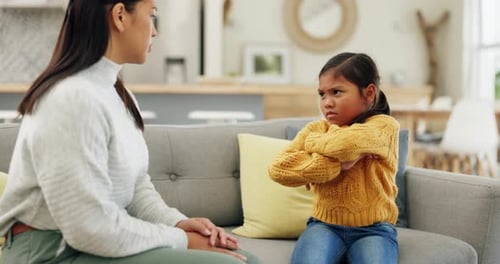 Mother and Child in Disagreement Indoors on Sofa
