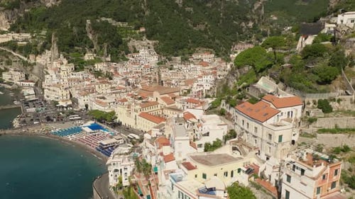 Drone rotating away from the Amalfi village, sunny day in Salerno, Italy