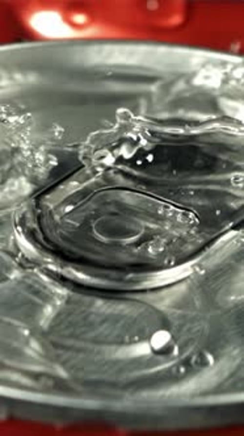 Drops of Water Fall on a Can of Cola