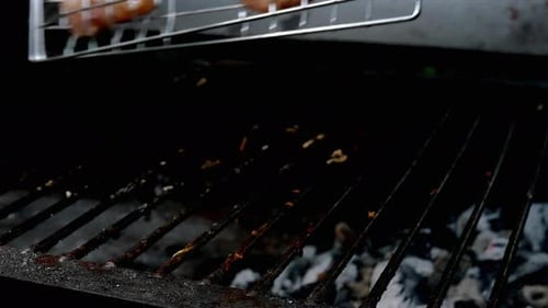 Pieces of Juicy Chicken Fillet Fried on Burning Charcoal on Grill Grate Turning