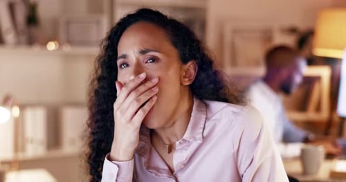 Tired Woman Yawns in Office Setting
