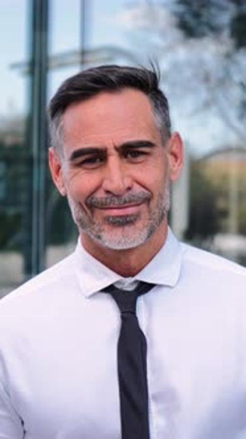 Vertical Close Up Portrait of Successful Mature Business Man Smiling Looking at Camera Standing