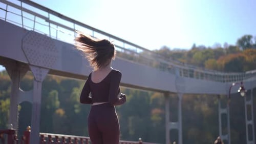 A Young Woman Runs in a Scenic Park Enjoying Her Workout and Staying Fit and Healthy