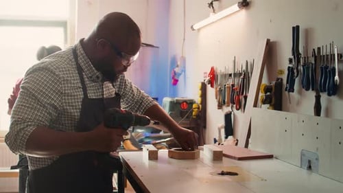 Man Crafts Wood in Workshop with Power Tools