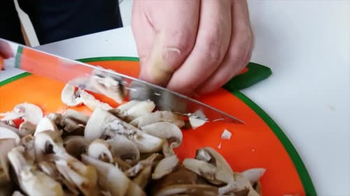 Chef Cutting Fresh Mushrooms with Sharp Knife