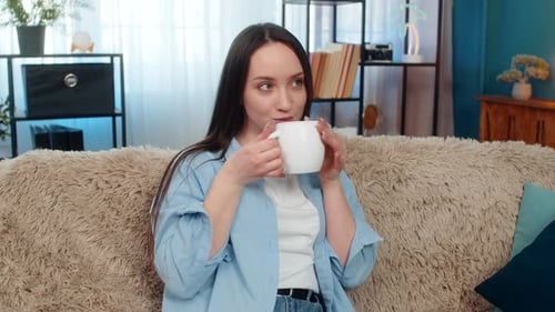 Woman Relaxing with a Warm Drink at Home