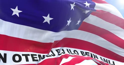 Waving American Flag with Textured Fabric and Blue Sky Background