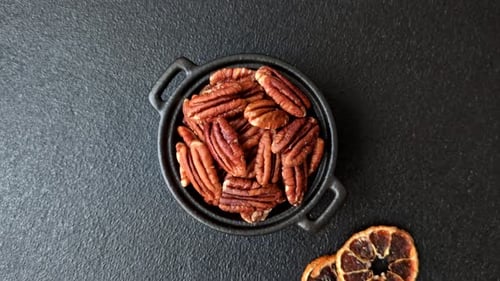 Peeled and roasted pecan nut as an ingredient for healthy food. Pecan nut as a food background
