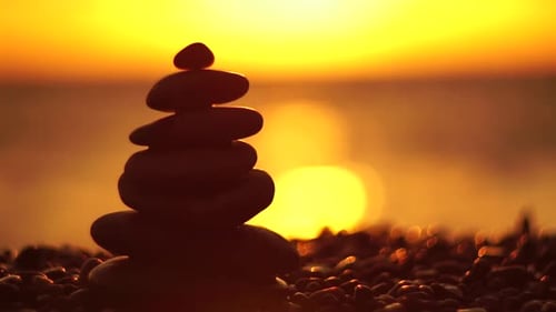 Balanced Rock Pyramid on Pebbles Beach Sunny Day and Clear Sky at Sunset