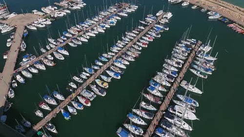 Boats and small sailing Yachts docked in a beautiful marina, Top down view