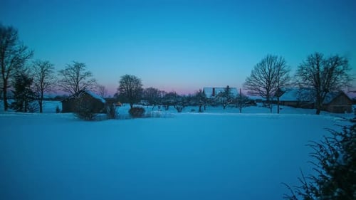 Winter Sunrise Over Snow Covered Rural Landscape