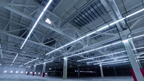 Expansive Empty Warehouse Interior with Bright Lighting