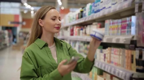 Woman Shopping for Cosmetics in Supermarket Aisle
