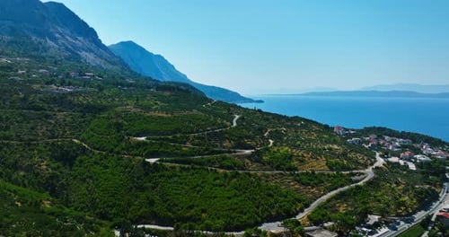 Aerial view of a winding road in the mountains of Makarska riviera in sunny Croatia
