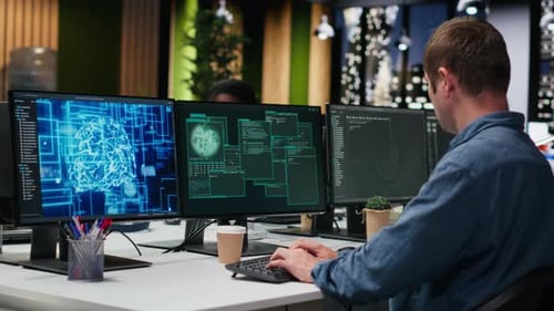 System Administrators in Office Working Together to Block Hacker Intrusion