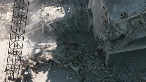 Excavator Working Rubbish in a Demolition Site Top Down Wide Drone Footage of Destroyed Buildings