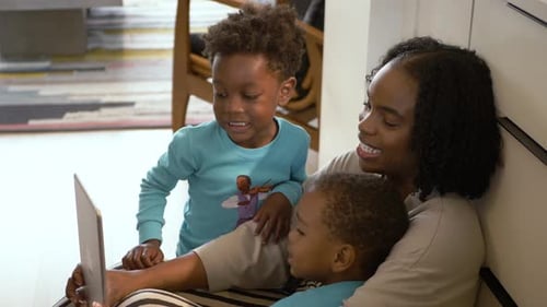 Happy mother and children using a tablet device