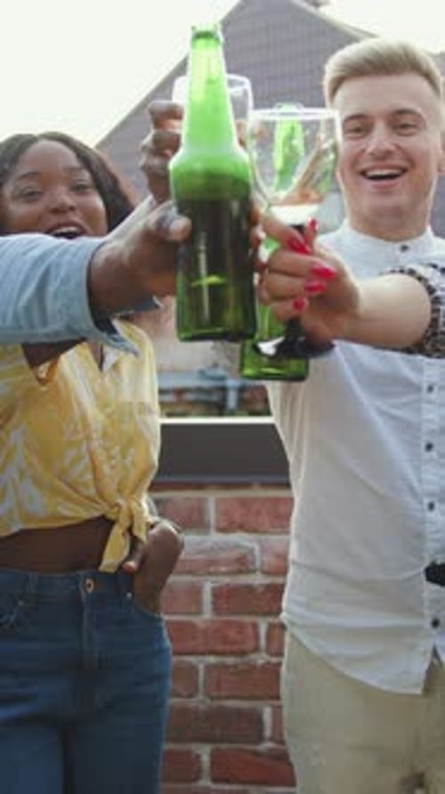 Friends Toasting with Drinks on Urban Rooftop Patio