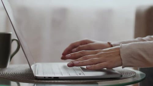 Close Up of Hands Typing on Laptop