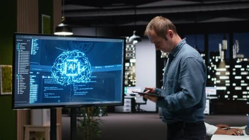 Manager in Office Analyzes Machine Learning Algorithms Built By Workers
