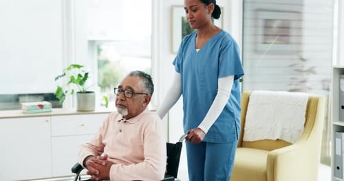 Woman Assists Senior Man in Wheelchair