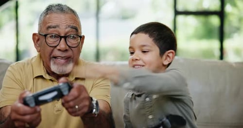 Grandfather and Child Gaming Together at Home