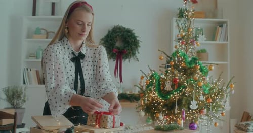 Joyful Woman Decorating Wrapping Christmas Gifts For Xmas Holidays