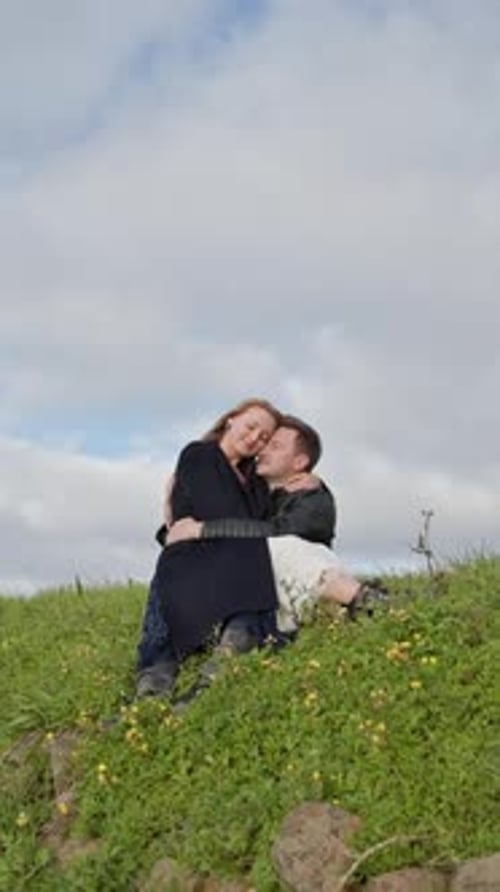 Affectionate Couple Embracing on a Hillside