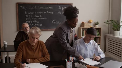 Instructor Helping Mature Students in a Classroom Setting