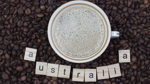 Top View of a Cup of Coffee on a Background Coffee Beans with the Inscription Australia