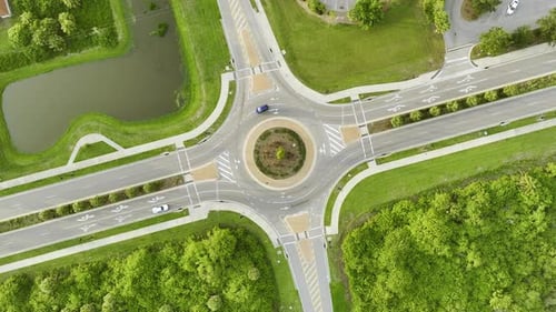 Aerial View of Road Roundabout Intersection with Moving Cars Traffic