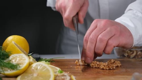 Cutting Walnuts on a Board with Lemons