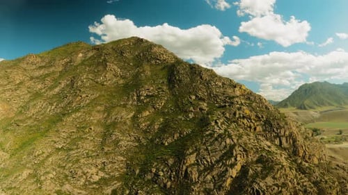 Steep Rocky Mountain Peak at Glowing Sunlight Aerial View