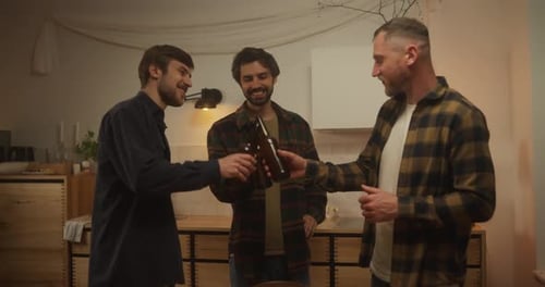 Three Men Toasting Beer in Living Room