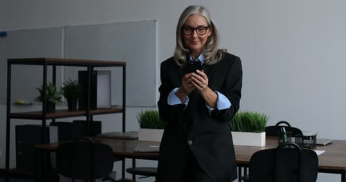 Professional Woman Using Phone in Modern Office