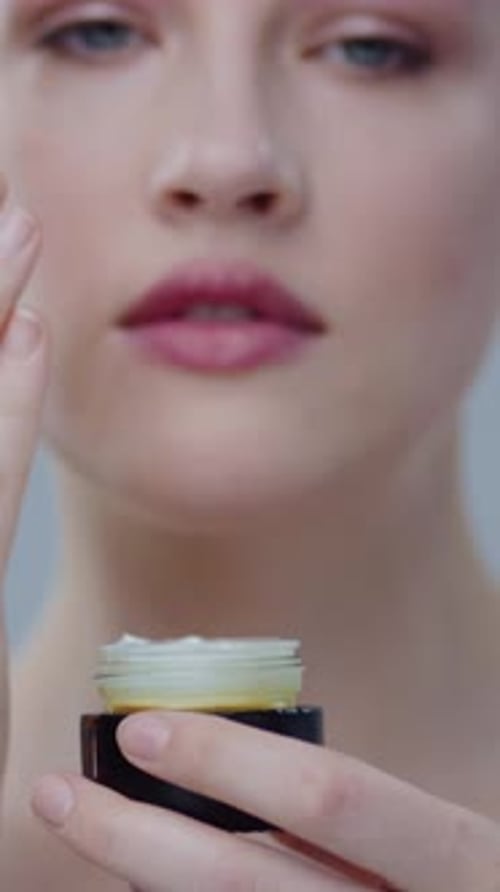 Woman Applying Skincare Cream