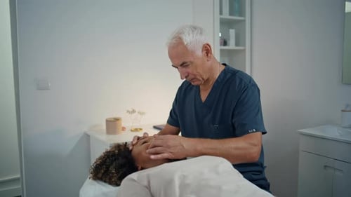 Doctor Examines Woman's Face in Medical Clinic