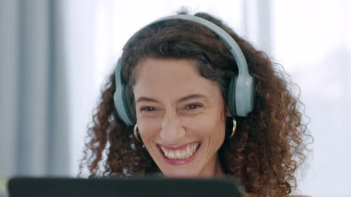 Happy senior woman streaming a comedy movie or stand up comic online via an internet connection