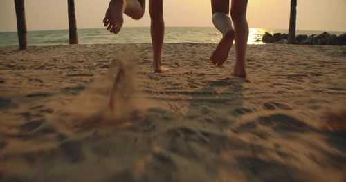 Slow motion: Close up Women friends running enjoy life playing and freedom beach at sunset
