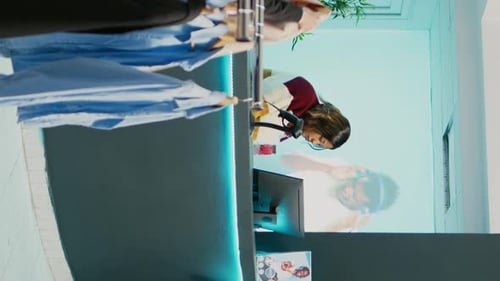 Vertical Video Asian Person Paying for Merchandise at Cash Register
