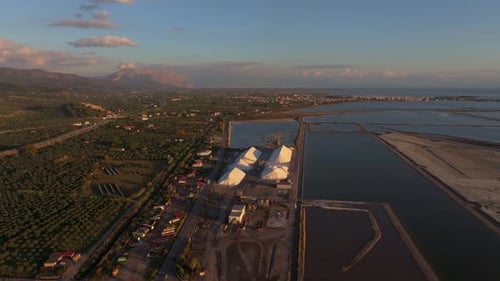 Aerial view of salt pans and factory at sunset, Greece.