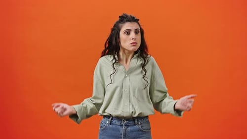 Caucasian Young Doubtful Woman 30s Shrugging Shoulders in Hesitation Gesturing Do Not Know Sign