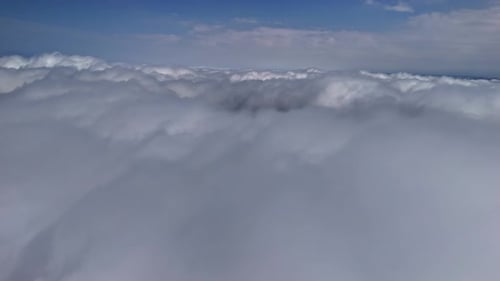 Luftflug über endlosen weißen Wolken