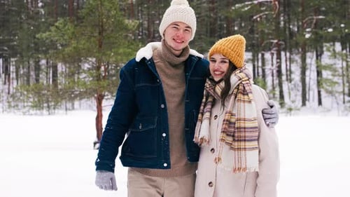 Affectionate Couple Embracing in Snowy Winter Forest