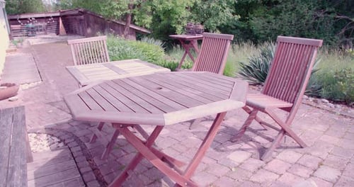 Garden furniture on terrace in beautiful garden