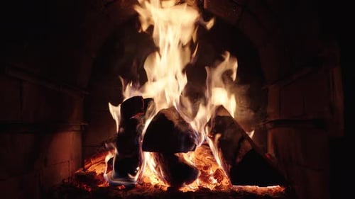 Roaring Fireplace with Bright Flames in Stone Hearth