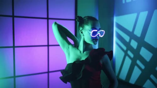 Modern Young Woman in Fluorescent Glasses Dancing Over Color Neon Light Background Sexy Lady Concept