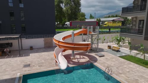 Aerial View Fun Day at the Pool With a Water Slide People Enjoying the Water